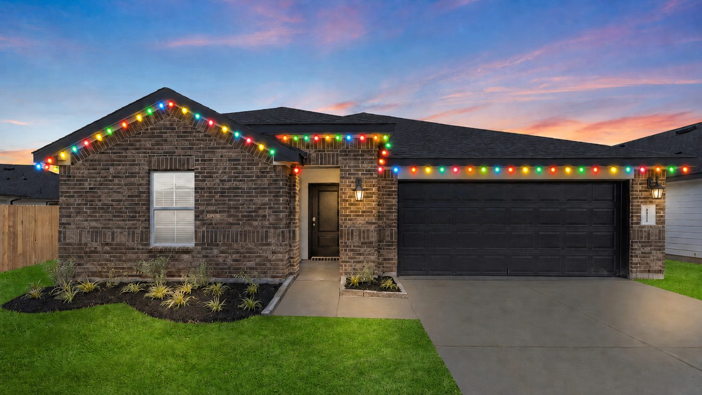 Single story home with multicolor Christmas roofline lights