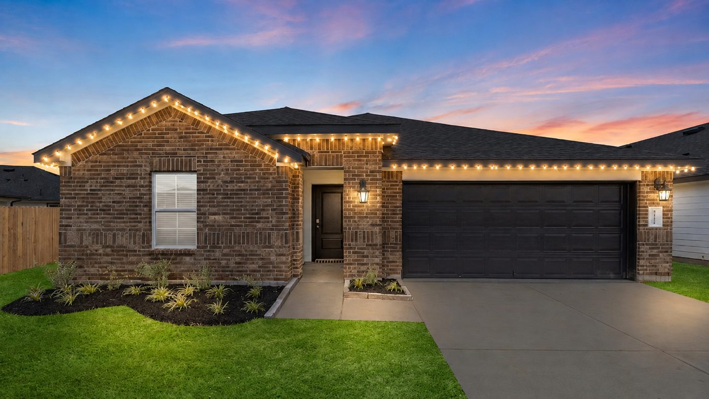 Single story home with warm white Christmas roofline lights